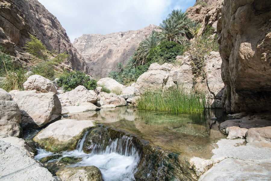 Planning a trip to Oman? You HAVE to visit Wadi Shab! Click to read how to get to Wadi Shab, what to expect when you arrive, plus why you should plan a trip there (and to Oman). | Oman Travel | Muscat to Wadi Shab | Sur to Wadi Shab | Oman Road trip | Wadi Shab Guide